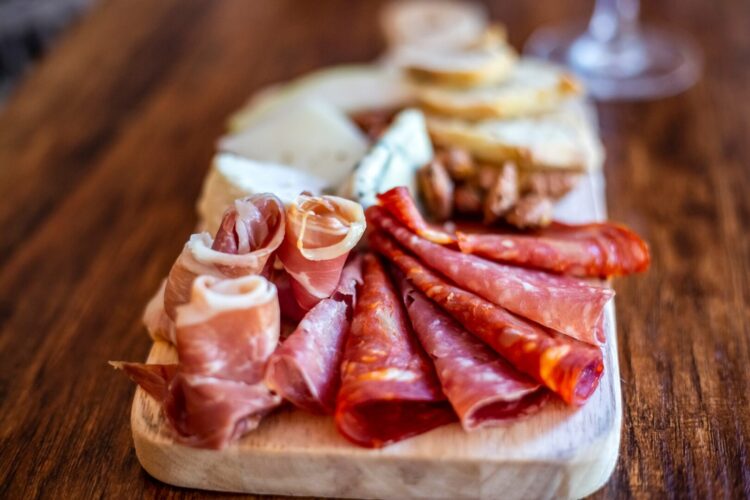 Side View of a prepared and plated charcuterie board with an up close view of the cured meats.